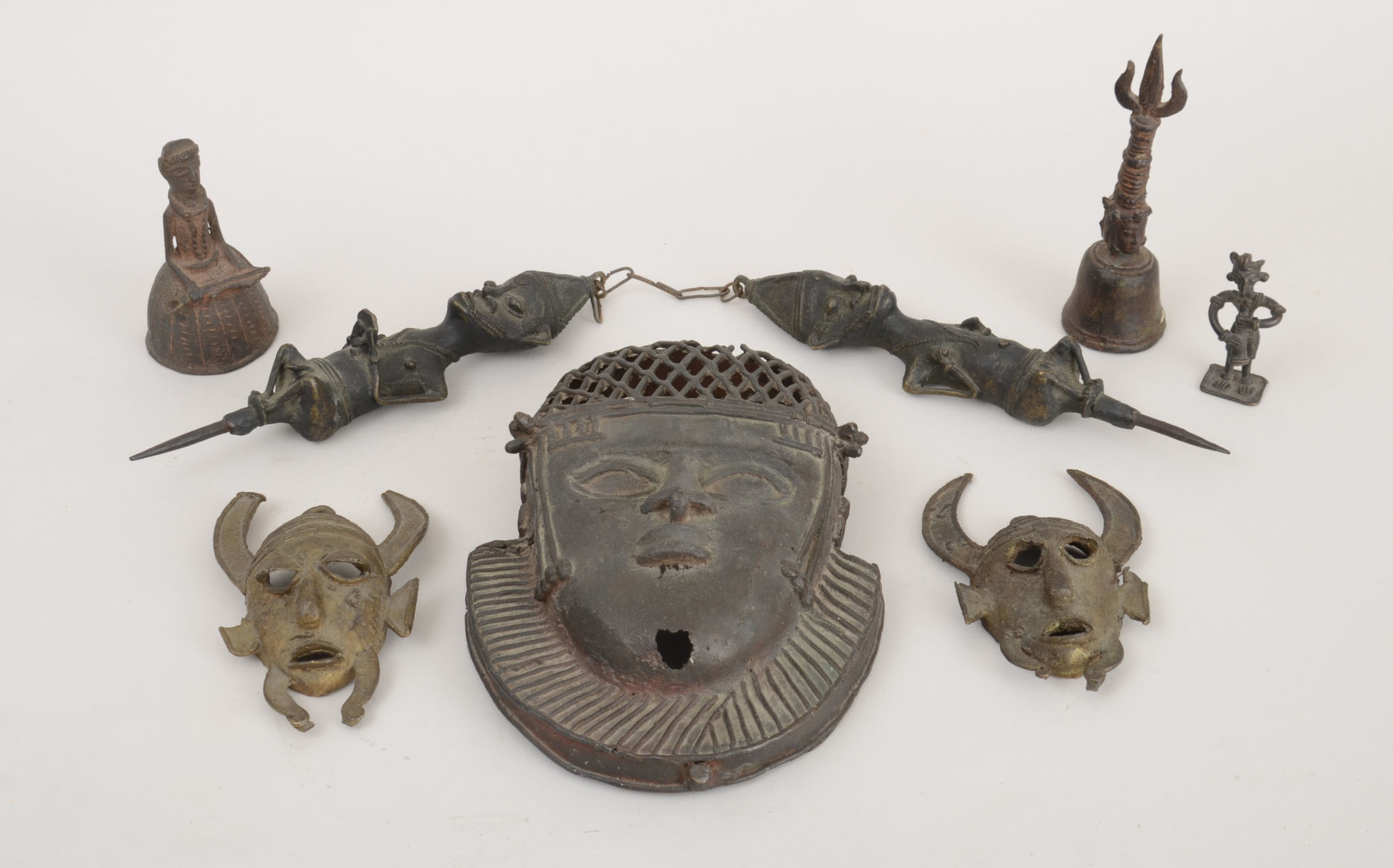 SIX BENIN TYPE BRONZE ARTICLES AND A TIBETAN HAND BELL