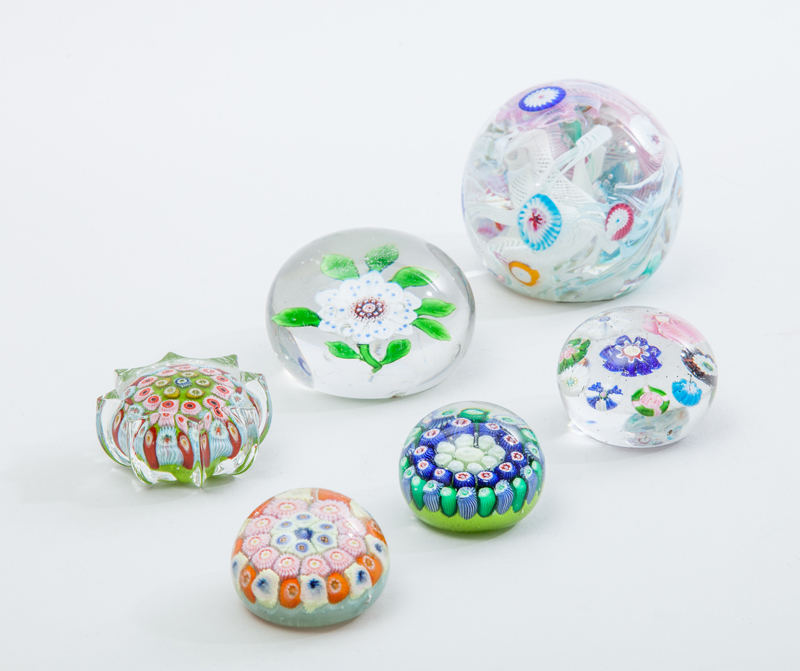 Four Glass Millefiori Paperweights, a Clematis Weight and a Scramble Weight