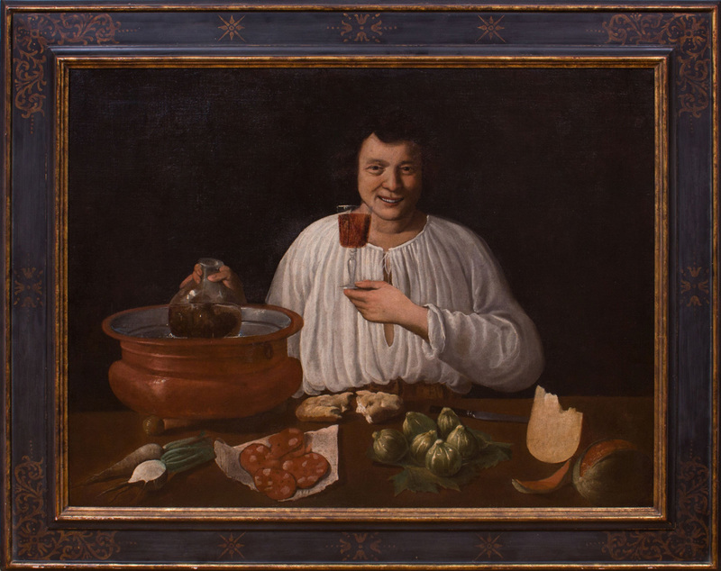 ITALIAN SCHOOL: A SMILING MAN, HOLDING A GLASS OF WINE AT A TABLE, WITH SALAMI, TURNIPS, CHEESE, BREAD, FIGS, MELON AND A COOLING BU...