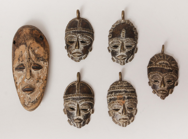 Five African Brass Miniature Face Mask Pendants and a Lugea (Congo) Carved and Painted Wood Mask