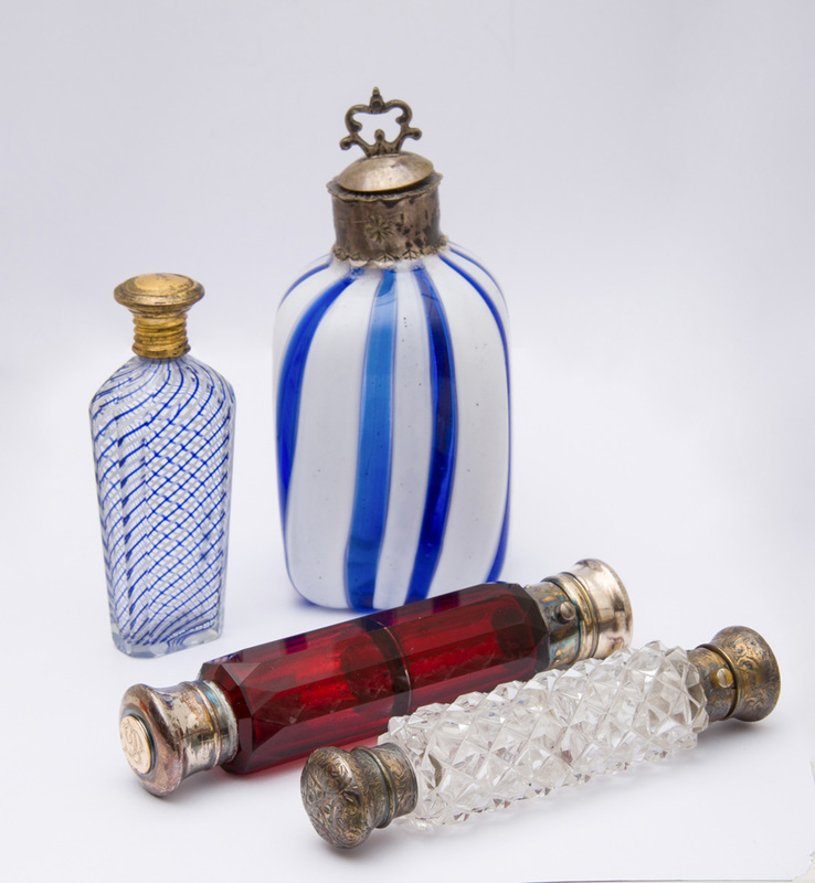 GROUP OF FOUR GLASS SCENT BOTTLES WITH METAL LIDS