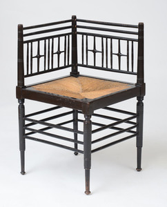 ENGLISH AESTHETIC MOVEMENT EBONIZED BEECH AND RUSH SEAT CORNER CHAIR, AFTER FORD MADDOX BROWN FOR LIBERTY & CO.