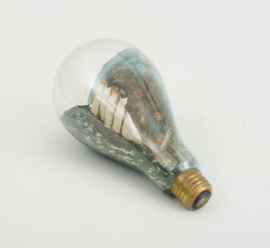 CARVED AND PAINTED SCHOONER MODEL, IN A GLASS LIGHT BULB