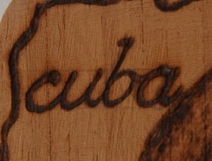 Framed Che Guevara Poster, an Elian Gonzalez poster, and a Burnt Wood Hanging Plaque of Fidel Castro