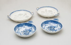 PAIR OF WEDGWOOD PEARLWARE TEA STRAINERS AND ANOTHER PAIR OF TRANSFER-PRINTED STRAINERS