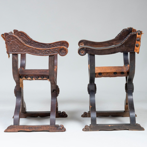 Two Italian Carved Walnut and Leather Curule Chairs